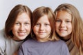 The faces of three girls sisters close-up on a white background Royalty Free Stock Photo