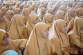 Faces of young Indonesian Muslim women at a religious event