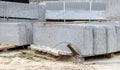 Faceted granite curbs on a pallet. Smooth porcelain stoneware products at the construction site. Curbstone, a stack of concrete Royalty Free Stock Photo