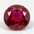 Faceted Round Brilliant Cut Ruby Gemstone with Deep Red Hue on a White Background precious stone Royalty Free Stock Photo