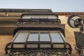 Facades of old houses with classic retro wrought iron old metal balconies with color patterns on an old brick building