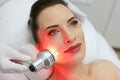 Facial Beauty Treatment. Woman Doing Red Led Light Therapy Royalty Free Stock Photo