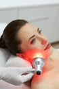 Facial Beauty Treatment. Woman Doing Red Led Light Therapy Royalty Free Stock Photo