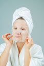 Facial care and beauty treatments. Beautiful woman with a sheet moisturizing mask on her face Royalty Free Stock Photo