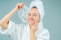Facial care and beauty treatments. Beautiful woman with a sheet moisturizing mask on her face Royalty Free Stock Photo