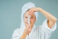 Facial care and beauty treatments. Beautiful woman with a sheet moisturizing mask on her face Royalty Free Stock Photo