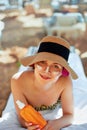 Facial Care. Young Female Holding Bottle Sun Cream and Applying on Face Smiling. Beauty Face. Royalty Free Stock Photo