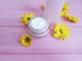 facial cream cosmetic daisy yellow flowers pink wooden Royalty Free Stock Photo