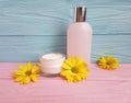 facial cream cosmetic yellow flowers pink wooden Royalty Free Stock Photo