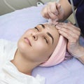 Facial cupping vacuum massage in spa. Beautiful girl in wellness center. Royalty Free Stock Photo