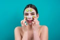 Facial mask of cucumber. Beautiful woman with facial mask with slices of fresh cucumber on face. Cosmetic masks on face Royalty Free Stock Photo