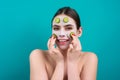 Facial mask of cucumber. Beautiful woman with facial mask with slices of fresh cucumber on face. Cosmetic masks on face Royalty Free Stock Photo