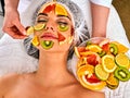 Facial mask from fresh fruits for woman . Beautician apply slices. Royalty Free Stock Photo