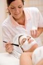 Facial mask - Woman at beauty salon Royalty Free Stock Photo