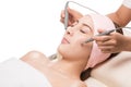 Facial massage,Peaceful brunette getting micro dermabrasion from beauty therapist Royalty Free Stock Photo