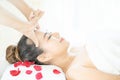 Facial Massage, Spa Massage, Relaxing facial massage at spa salon. Happy young beautiful woman enjoying head massage at the spa Royalty Free Stock Photo