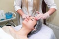 Facial massage. Young beautiful woman getting professional face treatment. Spa, resort, beauty and health concept Royalty Free Stock Photo