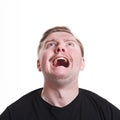 Facial negative expressions. Shouting man looking up, isolated on white background Royalty Free Stock Photo