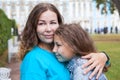 Facial portrait of mother embracing her teenage daughter, Caucasian long hair people, outdoors Royalty Free Stock Photo