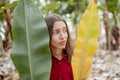 Beautiful woman with banana leaves on the plantation Royalty Free Stock Photo