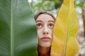 Beautiful woman with banana leaves on the plantation Royalty Free Stock Photo