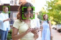 Facial recognition system identifying people on city street Royalty Free Stock Photo