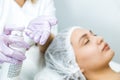 Facial skin care and protection. A young woman at a beauticians appointment. The specialist cleans the skin before