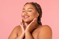 Happy Oversized Black Female Touching Face Over Pink Studio Background