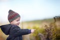 Facinated by nature. A cute little boy pointing at something while outside. Royalty Free Stock Photo
