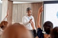 Facing the Challenges. Asian male speaker answering questions while giving a talk at corporate business meeting, forum Royalty Free Stock Photo