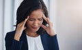 Facing the stresses of the day. a young businesswoman looking stressed out in an office. Royalty Free Stock Photo