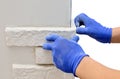 Facing wall decorative tiles, workers in blue glove Royalty Free Stock Photo