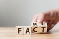 Fact or Fake concept, Hand flip wood cube change the word, April Royalty Free Stock Photo