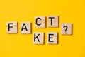 fact or fake words with a question on a yellow background Royalty Free Stock Photo