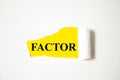FACTOR the text is written on a white background and a yellow piece of paper Royalty Free Stock Photo