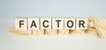 FACTOR word written on wood block on white Royalty Free Stock Photo