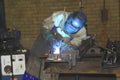 Factor worker welding closely