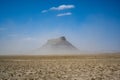 Factory Butte surrounded by dust and debris Royalty Free Stock Photo