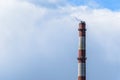 Factory Chimney of a power plant with a small stream of smoke