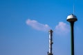 Factory chimney and the water tower tank on blue sky Royalty Free Stock Photo