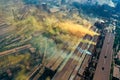 Factory chimneys emit a caustic chemical fume that disrupts the city's ecology