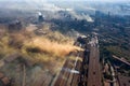 Factory chimneys emit a caustic chemical fume that disrupts the city's ecology