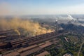 Factory chimneys emit a caustic chemical fume that disrupts the city's ecology