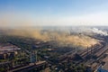 Factory chimneys emit a caustic chemical fume that disrupts the city's ecology