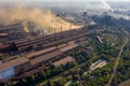 Factory chimneys emit a caustic chemical fume that disrupts the city's ecology