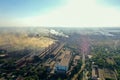 Factory chimneys emit a caustic chemical fume that disrupts the city's ecology