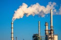 Factory chimneys release smoke into a clear blue sky, highlighting the impact of industrial pollution on global warming, Generated Royalty Free Stock Photo