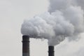 Factory chimneys smoking with dense white smoke. Industrial pollution of air, electric plant emission,  environment ecology proble Royalty Free Stock Photo