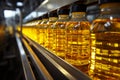 Factory conveyor line filling bottles with sunflower and vegetable oil in close up