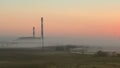 Factory at dawn in the mist timelaps